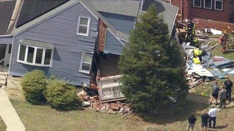 WATCH:  Driver trapped after dump truck slams into home